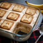 Mama's Banana Pudding with chess-themed cookies, a scoop revealing banana slices in a creamy layered dessert inside a glass dish.